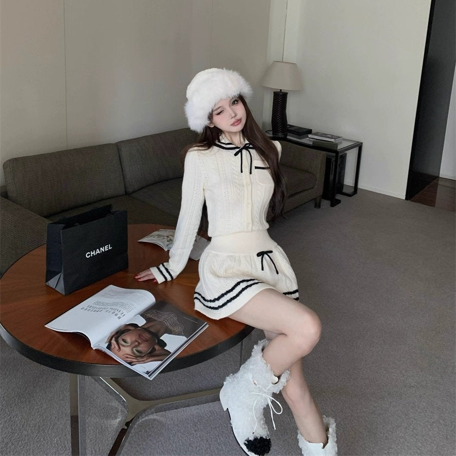 雪降る街を歩くお嬢様のホワイトリボンニットセットアップ_R0364